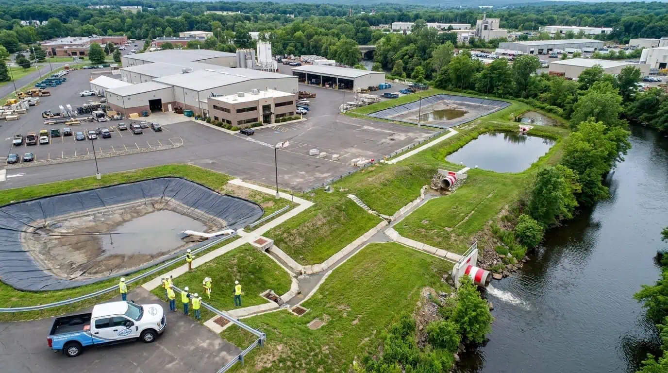 Aerial view of a Connecticut industrial facility with clearly marked stormwater outfalls and containment areas